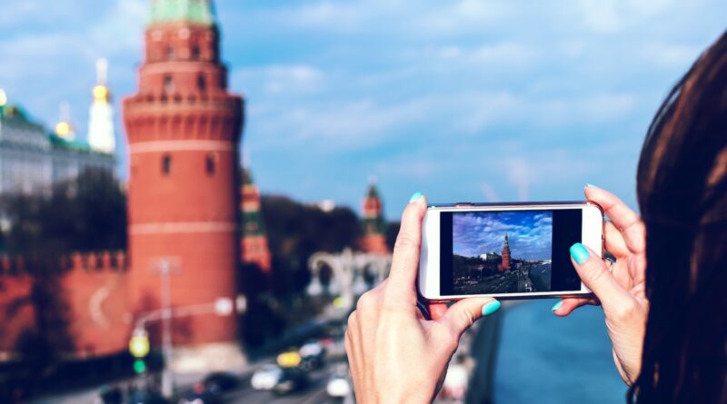 person holding white android smartphone taking photo of tower during daytime